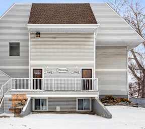 A two story house with a balcony on the second floor.