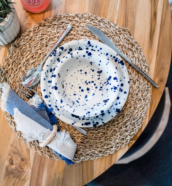 a wooden table with a bowl and a plate on top of it