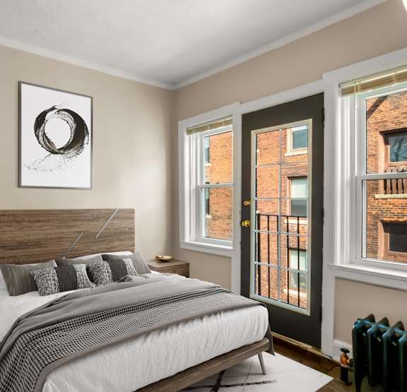 a bedroom with a bed and bookshelves     and a chair