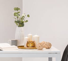 a white desk with a vase and candles on it at Timberstone, Charlotte, North Carolina