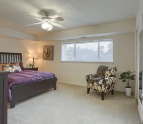 a bedroom with a large bed and a ceiling fan