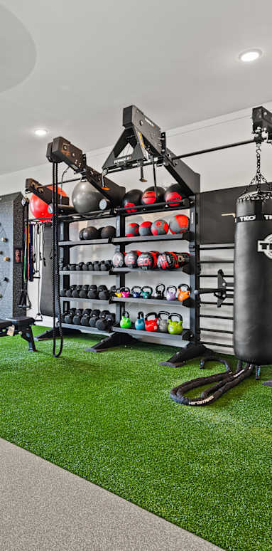 Home gym with a rock climbing wall and exercise equipment at Views at Flowers, Clayton, 27527