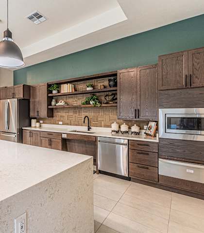 a large kitchen with a large island and a white counter top