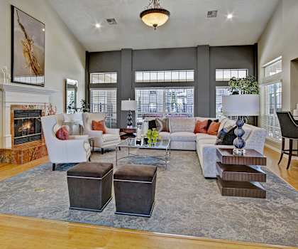 The lounge with a fireplace, couches, plush chairs, and coffee tables at Breckenridge. 