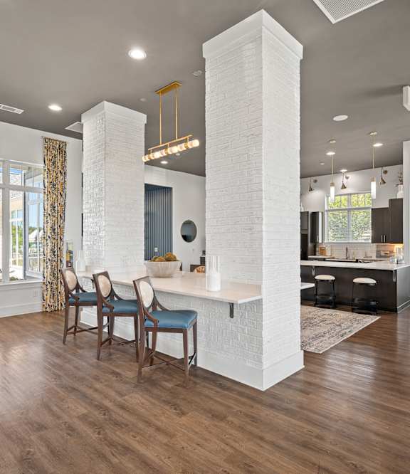 a living room with three mirrors and a wood floor