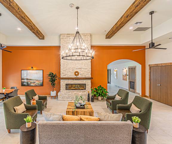 a living room with couches and chairs and a fireplace