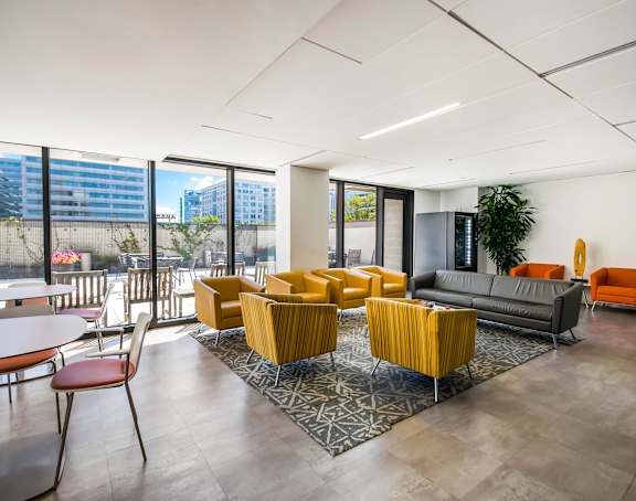 a living room with a kitchen and a balcony