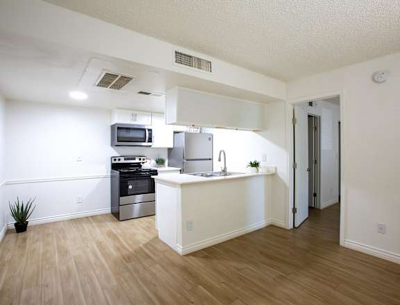 A kitchen with a stove top oven and a microwave.