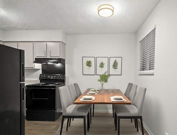 A black oven is in a kitchen next to a dining table.