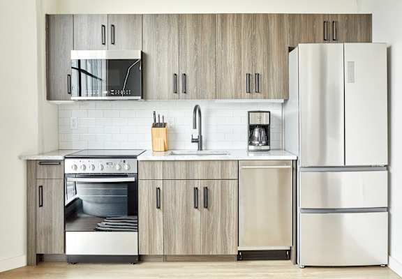 a kitchen with stainless steel appliances and wooden cabinets