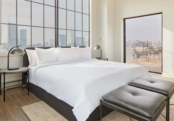 a hotel room with a bed and a large window