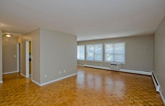an empty living room with wood flooring and a window at Park Edge, Massachusetts, 13502