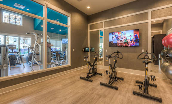 the gym at the enclave at woodbridge apartments in sugar land, tx  at EdgeWater at City Center, Lenexa, KS, 66219