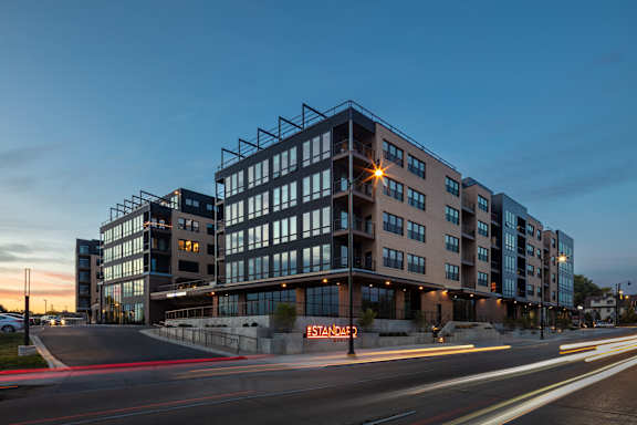 a large building with a street in front of it at night
