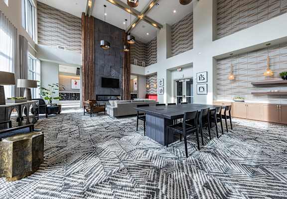 a large living room with a large table and chairs at The Monroe Apartments, Austin, 78741
