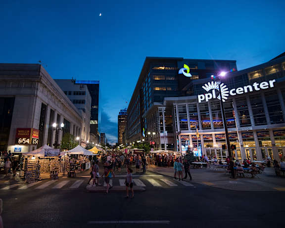people walking through a street festival in a city at night at 520 Lofts, Allentown