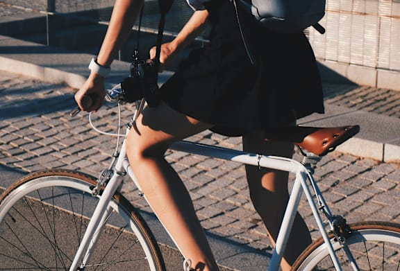 A person is riding a bicycle on a paved surface.