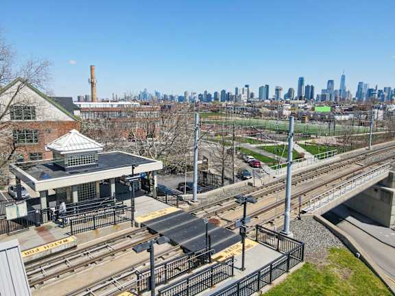 A train station with a city skyline in the background.at 829 Garfield, Jersey City, NJ 07305