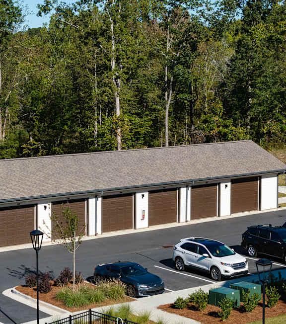 an aerial view of a building with cars parked in a parking lot