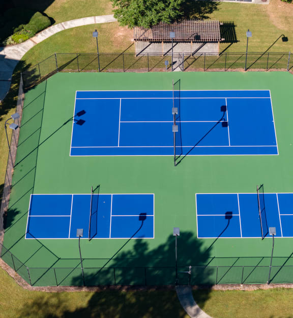 an aerial view of a tennis court with people on it