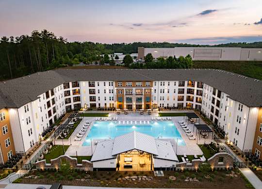 A large building with a pool in the middle of it.