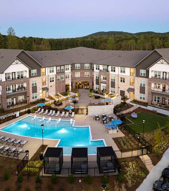 an aerial view of an apartment building and an outdoor pool