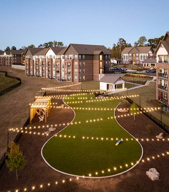 an aerial view of the courtyard at night with lights