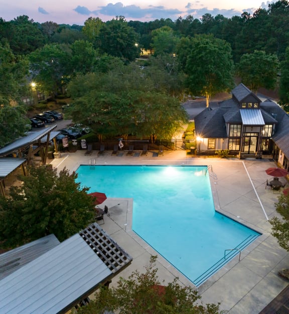 a view of the pool at the resort at night