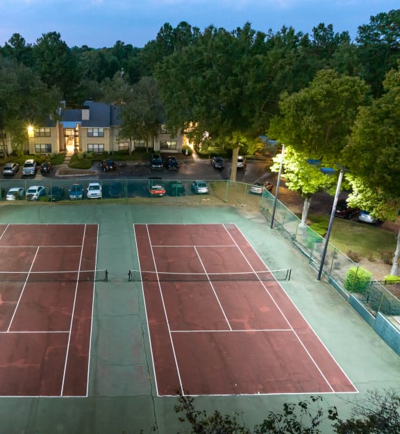 an aerial view of a tennis court at night