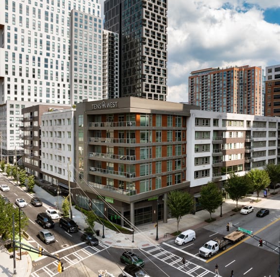 an aerial view of a building in a city with tall buildings