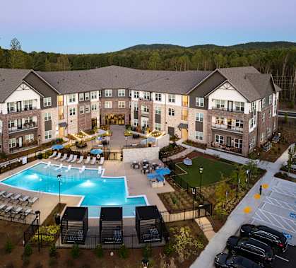 an aerial view of an apartment building and an outdoor pool