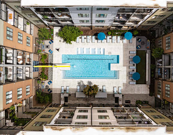 an aerial view of a swimming pool in the middle of a building