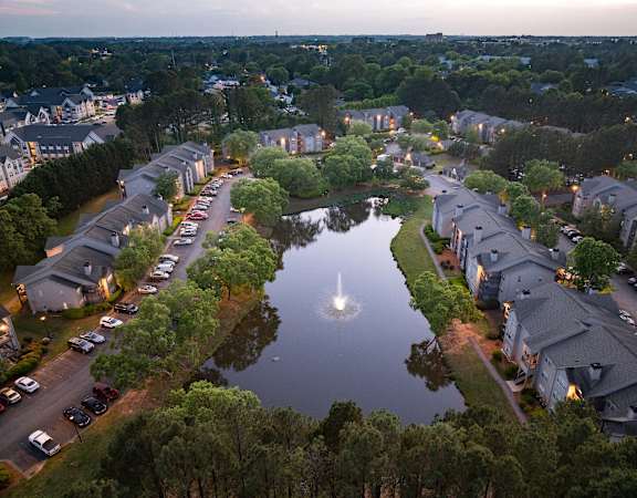 A beautiful aerial view of a residential area with a lake in the middle.