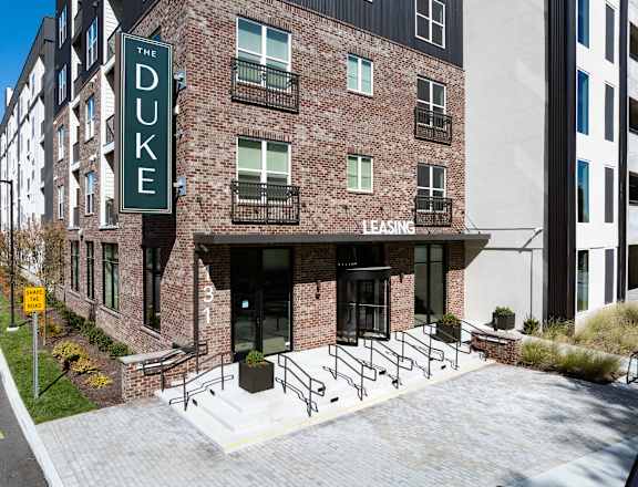 The Duke building is a brick apartment complex with a leasing office.