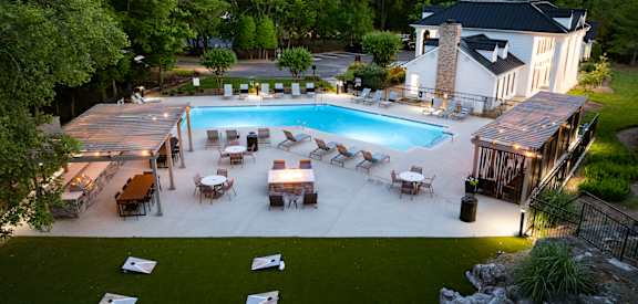 Aerial view of swimming pool and chairs at Ashton Brook apartments in Franklin