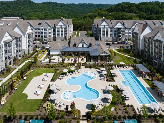 Overview of the outdoor pool area complete with social seating, and two pools at Novel Harpeth Heights