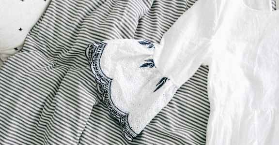 A striped shirt with a white shirt underneath it.