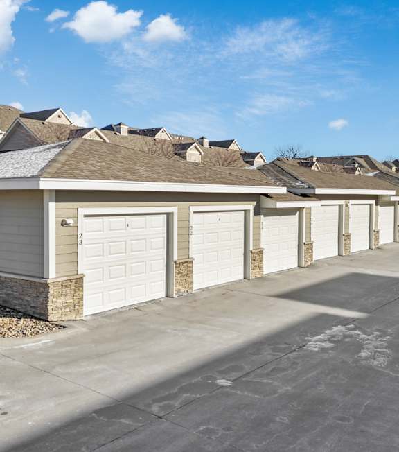 A row of houses with white garage doors.
