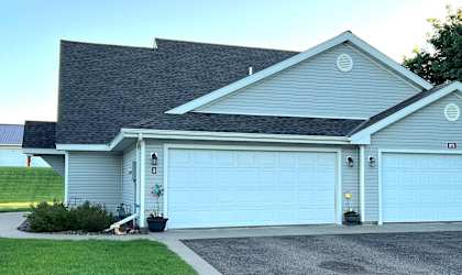 a blue house with a blue garage door