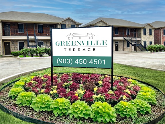 A sign for Greenville Terrace with a phone number on it.