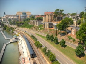 a view of a city with a river and a train