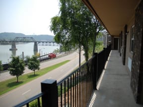 a balcony with a view of a river and a bridge