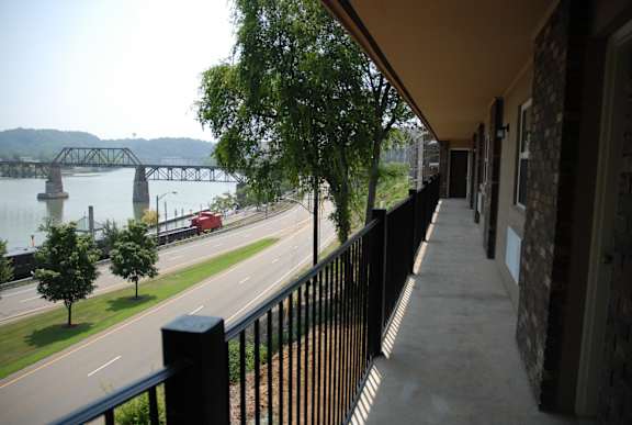 a balcony with a view of a river and a bridge