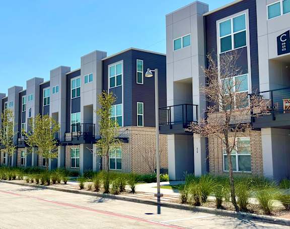 Discovery at the Realm Apartments Building Exterior and Lake with Wooden Pier