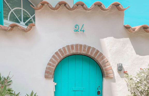 a blue door in a white building with a blue archway