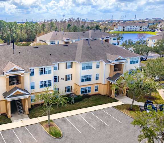 an aerial view of a large apartment complex with a lake in the background