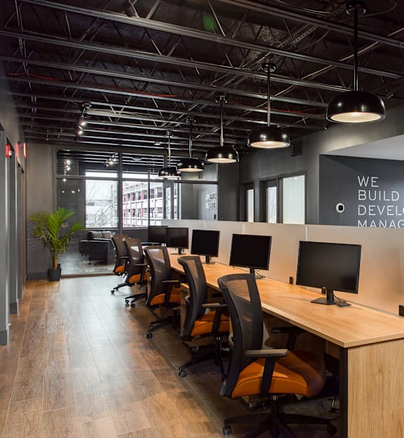 A modern office space with desks and computers.