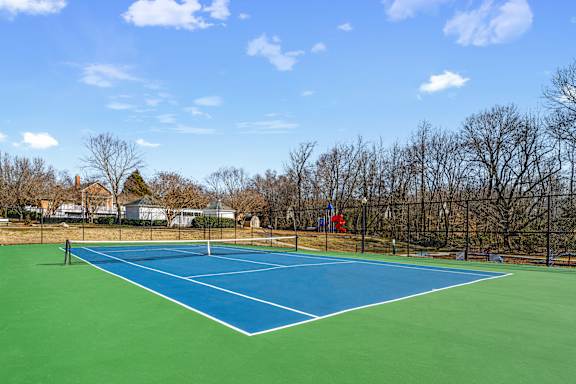 A blue tennis court with a net in the middle.