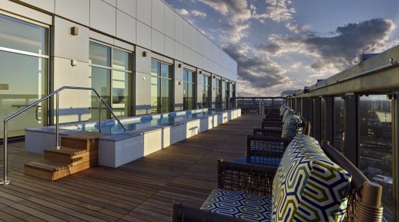 a patio with a grill and tables and chairs