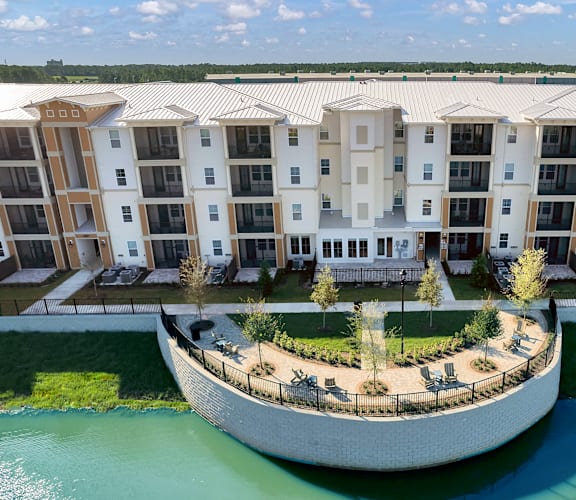 an aerial view of a building on a round island in the middle of a body of water